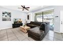 Spacious living area featuring a sectional sofa, coffee table, and a flat-screen TV at 8930 Sydney Ave, Kissimmee, FL 34747