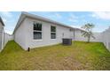 House exterior showcasing a grassy area and AC unit at 1052 Papaya Cir, Davenport, FL 33897