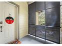 Front entry of a townhome with a white door and screen at 610 Celebration Ave # 1209, Celebration, FL 34747