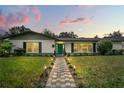 Mid-century modern home with teal door and walkway at 2350 Sherbrooke Rd, Winter Park, FL 32792