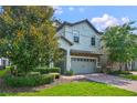 Two-story home with gray siding and brick driveway at 1435 Moon Valley Dr, Davenport, FL 33896