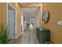 Modern entryway with wood wall and green cabinet at 1435 Moon Valley Dr, Davenport, FL 33896