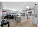 Spacious kitchen with large island, white cabinets, and granite countertops at 900 Sussex Close, Orlando, FL 32804