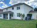 Rear view of the home showcasing backyard and patio area at 963 N Jacks Lake Rd, Clermont, FL 34711