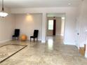 Bright dining room with beige walls and travertine tile flooring at 963 N Jacks Lake Rd, Clermont, FL 34711