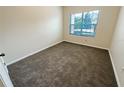 Simple carpeted bedroom with window at 4881 Cypress Woods Dr # 3213, Orlando, FL 32811