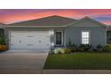 House exterior featuring a two-car garage and well-maintained lawn at 162 Piave St, Haines City, FL 33844