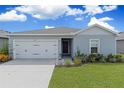 House exterior featuring a two-car garage and well-maintained lawn at 162 Piave St, Haines City, FL 33844