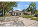 Newly renovated home with a stone facade and updated landscaping at 1523 Kelby Rd, Kissimmee, FL 34744