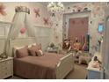 Charming bedroom with floral wall paper and window seat at 8208 Vineland Oaks Blvd, Orlando, FL 32835