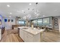 Modern kitchen with white cabinets, large island, and quartz countertops at 2210 Lelani Cir, Davenport, FL 33897