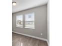 Simple bedroom with gray walls and wood-look flooring at 2141 Divot Drive Dr, Daytona Beach, FL 32124