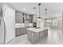 Modern kitchen with gray cabinetry, island, and stainless steel appliances at 2153 Divot Dr, Daytona Beach, FL 32124