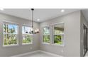 Bright dining room with large windows and a modern chandelier at 2153 Divot Dr, Daytona Beach, FL 32124