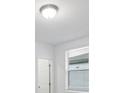 Bedroom with window, blinds, and white door at 3182 Viceroy Ct, Poinciana, FL 34759