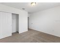 Bedroom with carpet flooring, a double-door closet, and an additional door at 3174 Viceroy Ct, Poinciana, FL 34759