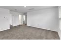 Spacious bedroom with gray carpeting and multiple doorways at 3793 Bluethread Way, Poinciana, FL 34759