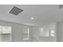 Upstairs hall with recessed lighting and windows with blinds at 3793 Bluethread Way, Poinciana, FL 34759