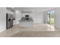 Modern kitchen with stainless steel appliances and granite island at 3206 Viceroy Ct, Poinciana, FL 34759