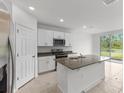 Modern kitchen with white cabinets, stainless steel appliances, and granite countertop at 3206 Viceroy Ct, Poinciana, FL 34759