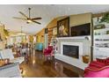 Open living room with hardwood floors, fireplace, and view into dining area at 4113 Fairview Vista Pt # 308, Orlando, FL 32804