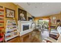 Living room features a fireplace, hardwood floors, and large windows at 4113 Fairview Vista Pt # 308, Orlando, FL 32804