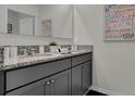 Double vanity bathroom with granite countertop at 3766 Bluethread Way, Poinciana, FL 34759