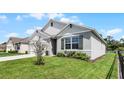 Gray house with dark gray shutters and landscaping at 976 August Sky Dr, Deltona, FL 32738