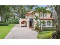 Two-story house with tile roof, arched entryway and brick driveway at 732 Edgewater Dr, Orlando, FL 32804