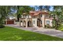 Large Spanish style home with a tile roof and landscaped yard at 732 Edgewater Dr, Orlando, FL 32804