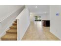 Spacious entryway with tile flooring and staircase leading upstairs at 9021 Carlotta Way, Kissimmee, FL 34747