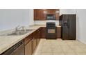 Modern kitchen with dark wood cabinets and stainless steel appliances at 9021 Carlotta Way, Kissimmee, FL 34747