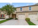 Two-car garage with beautiful landscaping and curb appeal at 9021 Carlotta Way, Kissimmee, FL 34747