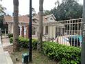 Community pool with lounge chairs and lush greenery at 575 Bloomington Ct # 27, Altamonte Springs, FL 32714