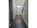 Spacious foyer with wood-look floors, a staircase, and front door at 1075 Trappers Trail Loop, Davenport, FL 33896