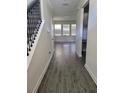 Bright foyer with wood-look tile floors and a staircase at 1075 Trappers Trail Loop, Davenport, FL 33896