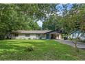 Charming ranch home with a covered carport and a neatly landscaped lawn at 2350 Pleasant Dr, Longwood, FL 32779