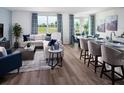 Open concept living room and kitchen with hardwood floors and stylish furniture at 3514 Rutland Ln, Haines City, FL 33844