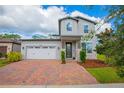 Two-story house with two-car garage and brick driveway at 2048 Napoli Dr, Saint Cloud, FL 34771