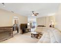 Spacious living room featuring a large sectional sofa and a view into the dining area at 3216 Lynrock Ave, Dundee, FL 33838