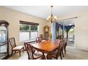 Bright dining room with a large wooden table and access to a patio at 3216 Lynrock Ave, Dundee, FL 33838