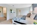 Main bedroom with carpeted floor, dresser, and en-suite bathroom at 2928 Waterlily Way, Poinciana, FL 34759