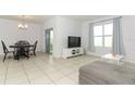 Bright dining area with table, chairs, and access to patio at 277 Ludisia Loop, Davenport, FL 33837
