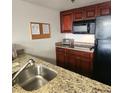 Well-equipped kitchen featuring granite countertops and modern appliances at 6336 Parc Corniche Dr # 3303, Orlando, FL 32821