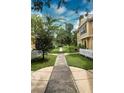 Paved walkway through a community with lush landscaping at 2601 Gala S Rd # 107, Kissimmee, FL 34746