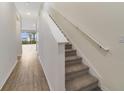 Modern staircase with light walls and carpeted steps at 707 Southern Edge Way, Sanford, FL 32771