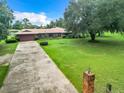 Brick ranch house with a long driveway at 4711 County Road 134, Wildwood, FL 34785