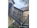 Exterior view of condo building with a metal staircase leading to the entrance at 6312 Raleigh St # 513, Orlando, FL 32835