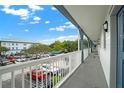 Hallway overlooking parking lot with white railings and blue doors at 720 Celebration Ave # 220, Celebration, FL 34747