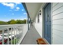 Hallway with white railings and blue doors leading to individual units at 720 Celebration Ave # 220, Celebration, FL 34747